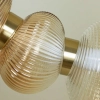 Designerska lampa wisząca LED w kolorze złotym do salonu