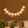 Designerska lampa wisząca LED w kolorze złotym do salonu